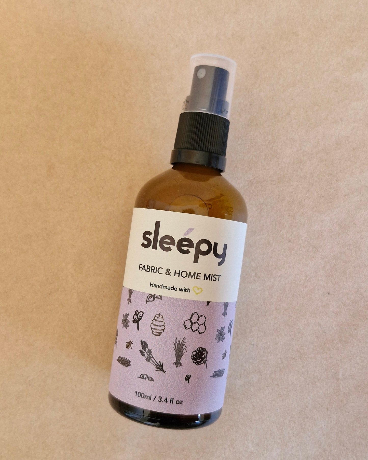 Bottle of 'sleepy' fabric and home mist on a beige background