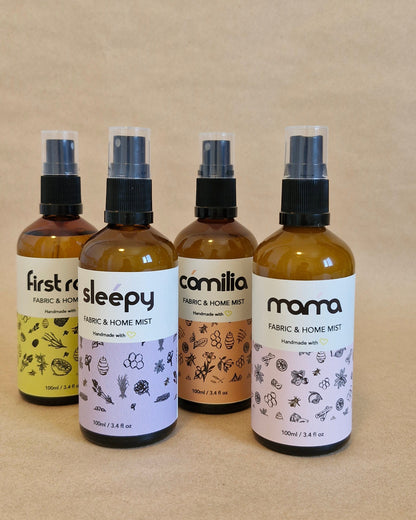 Set of four bottles with labels on a beige background