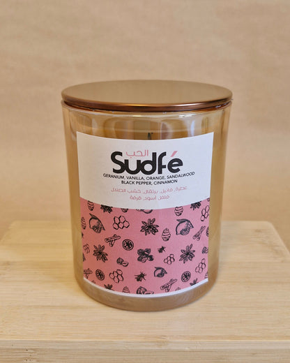 Jar with a pink label on a wooden surface