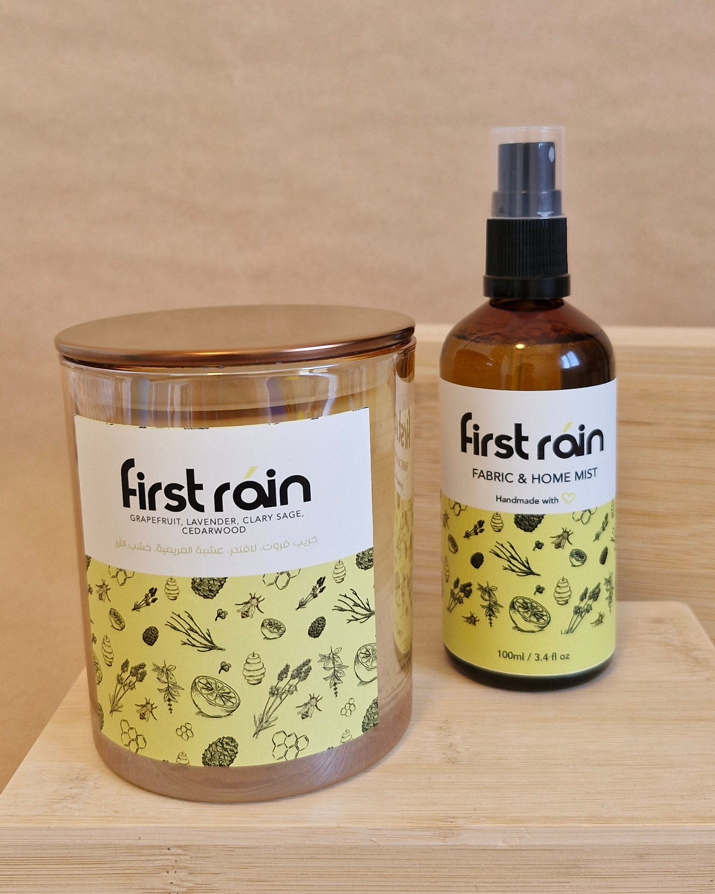 Two bottles of 'First Rain' on a wooden surface