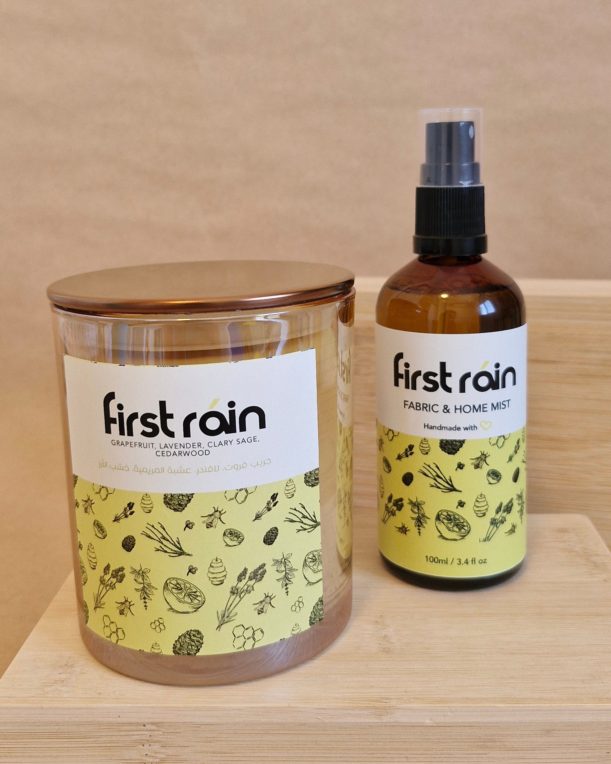 Two bottles of 'First Rain' on a wooden surface