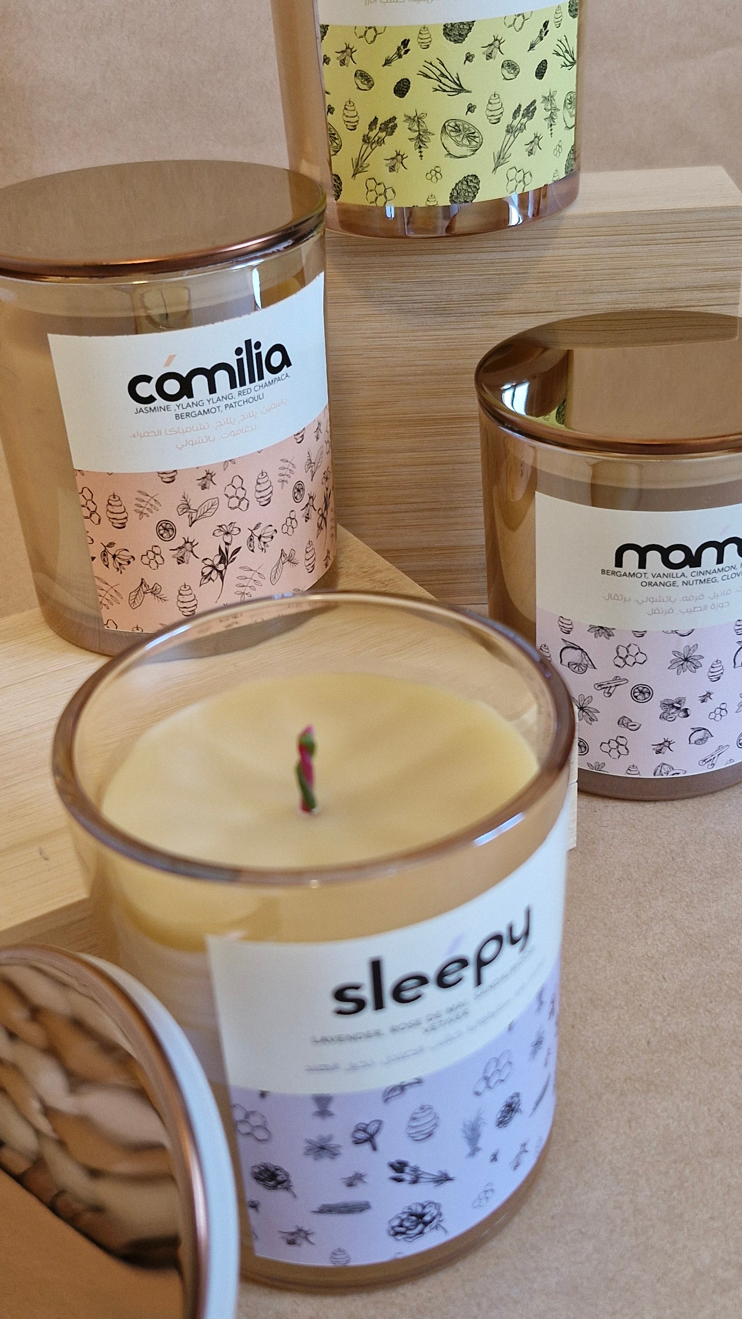 Candles with labels on a wooden surface