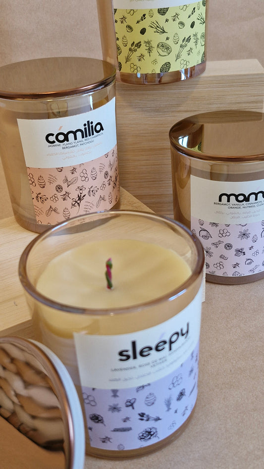 Candles with labels on a wooden surface